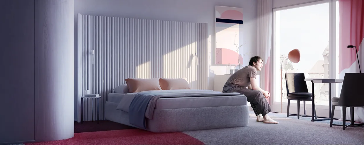 Wizualizacja pokoju hotelowego,na łóżku siedzi mężczyzna patrzący w okno, jasne wnętrze z czerwonymi dodatkami